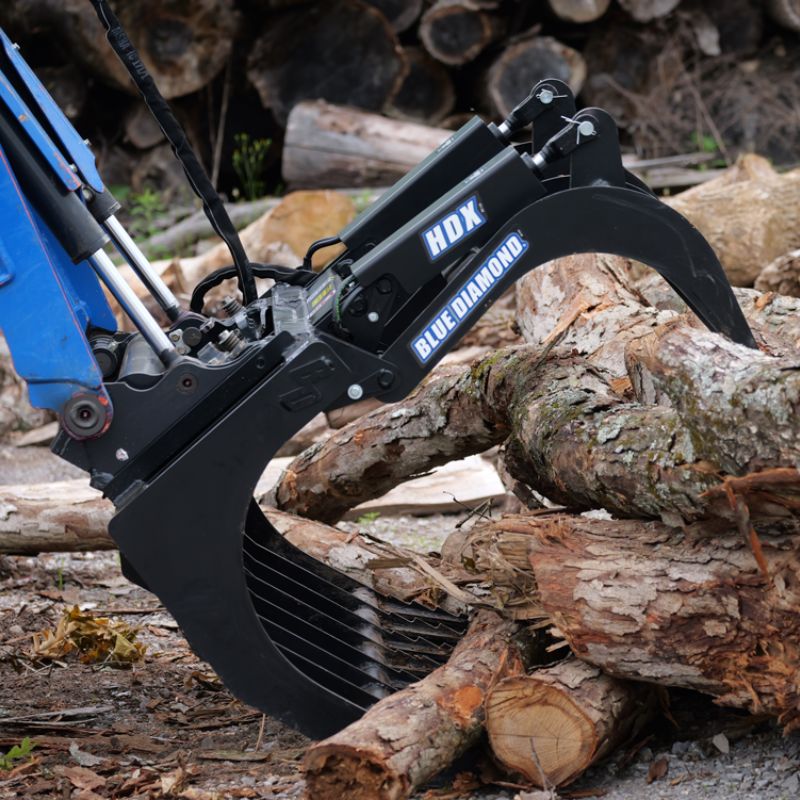 Blue Diamond HDX grapple attachment lifting cut logs