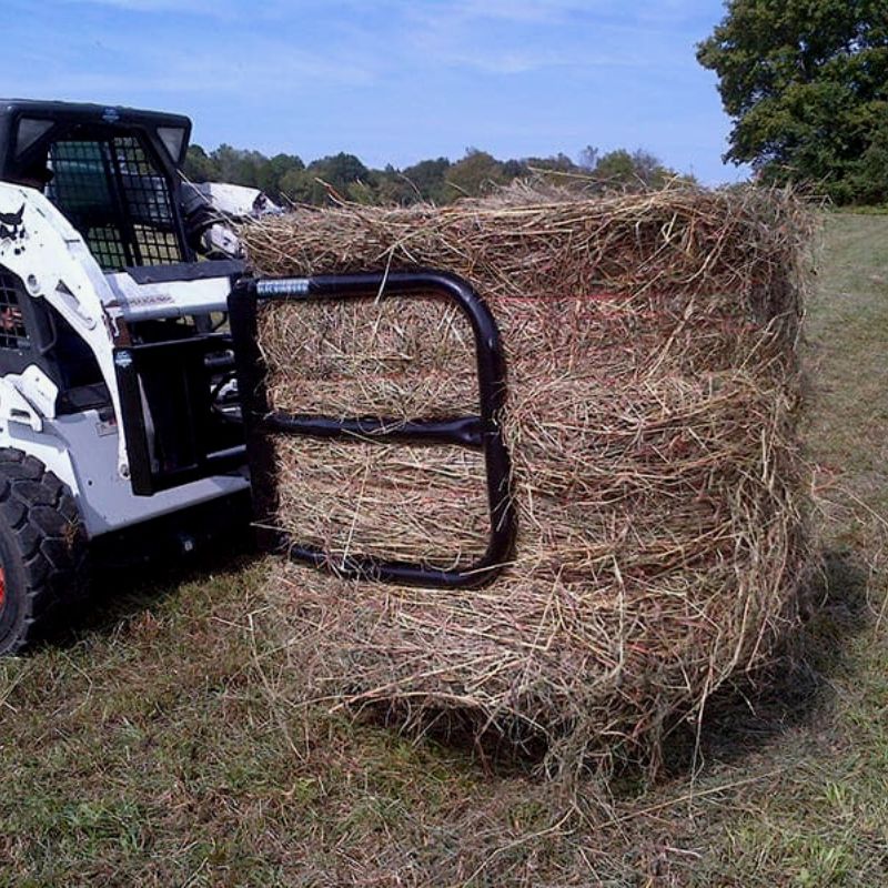 Skid Steer with Blue Diamond Bale Squeeze Attachment in Action