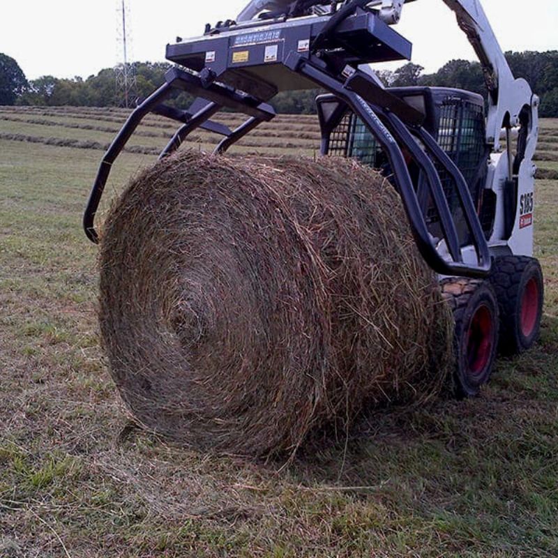 Bale Squeeze Hydraulic Round of Blue Diamond in the field picking bales.