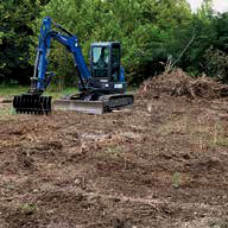 excavator with the blue diamond rake in action