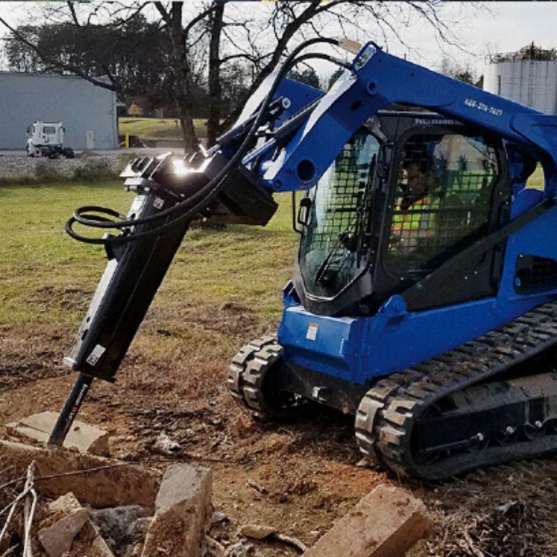 skid steer with the blue diamond mount hammer breaker in action