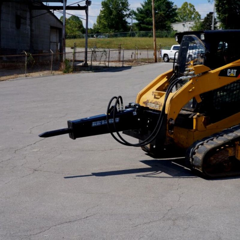 skid steer ready to break the ground with the blue diamond hydraulic breaker attachment