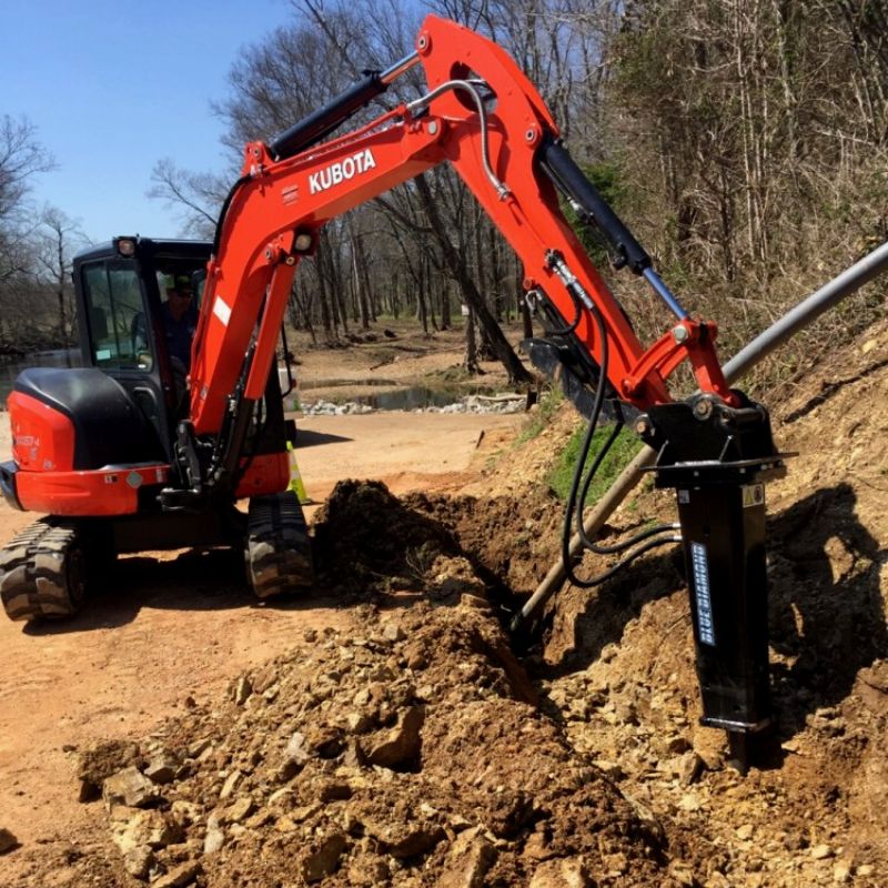 Kubota skid steer with Blue Diamond Hydraulic Breaker attachment in action