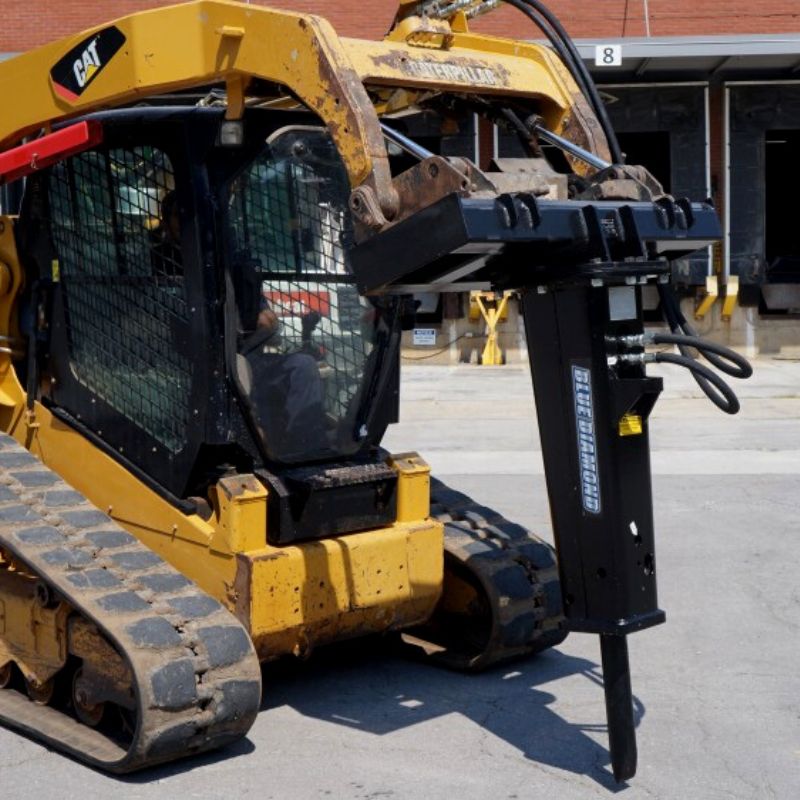 cat skid steer with the blue diamond breaker attachment