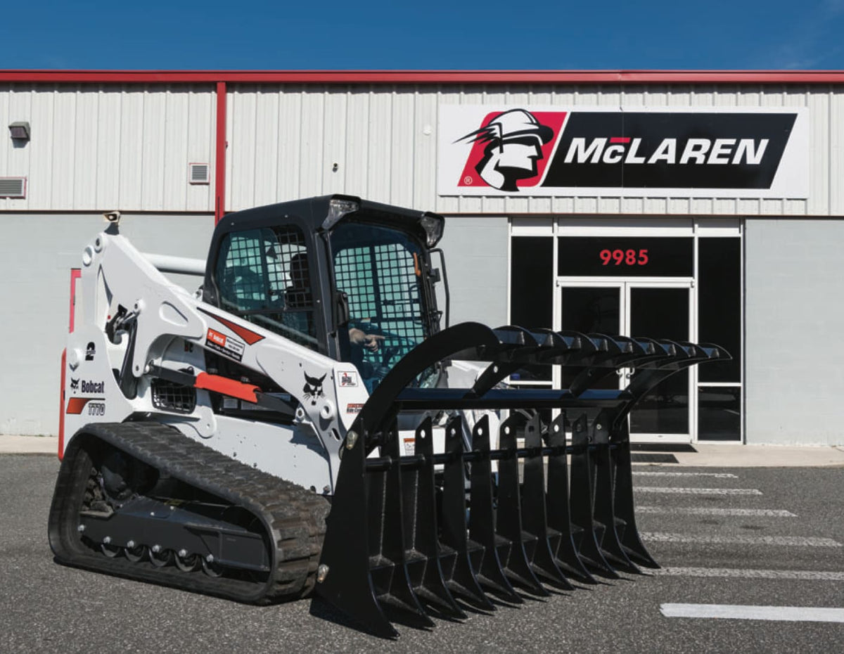 bobcat skid steer with the clam style root rake grapple attachment from mclaren industries