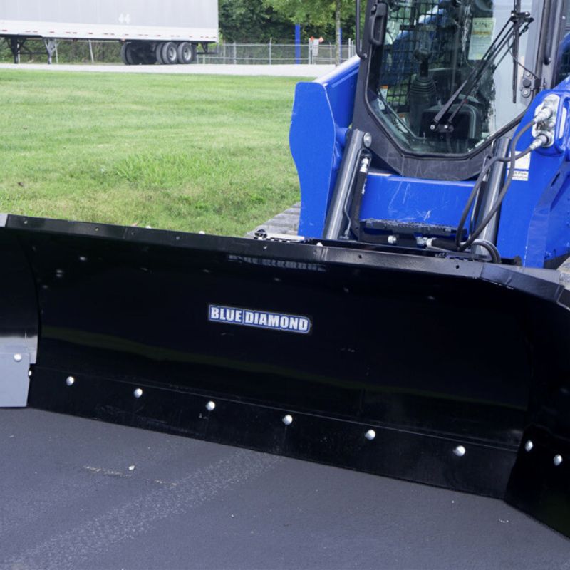 skid steer with the blue diamond autowing plow blade in action