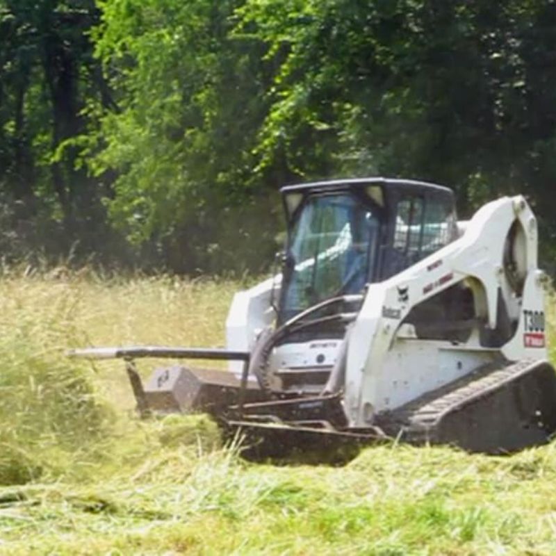 Bobcat mini skid steer in use with the Brush Cutter Extreme Duty Open Front by Blue Diamond