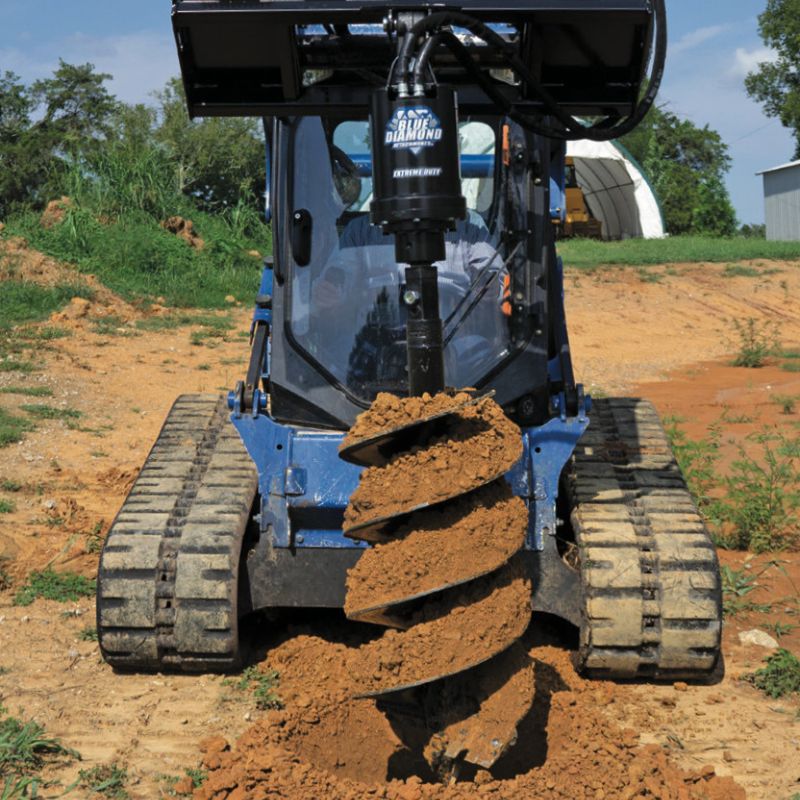 extreme duty auger on a skid steer in action
