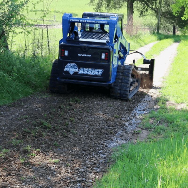 blue diamond extreme duty power rake in action with skid steer