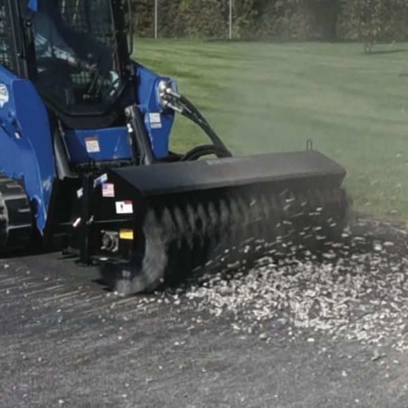 skid steer in action with the blue diamond heavy duty series 2 angle broom sweeper