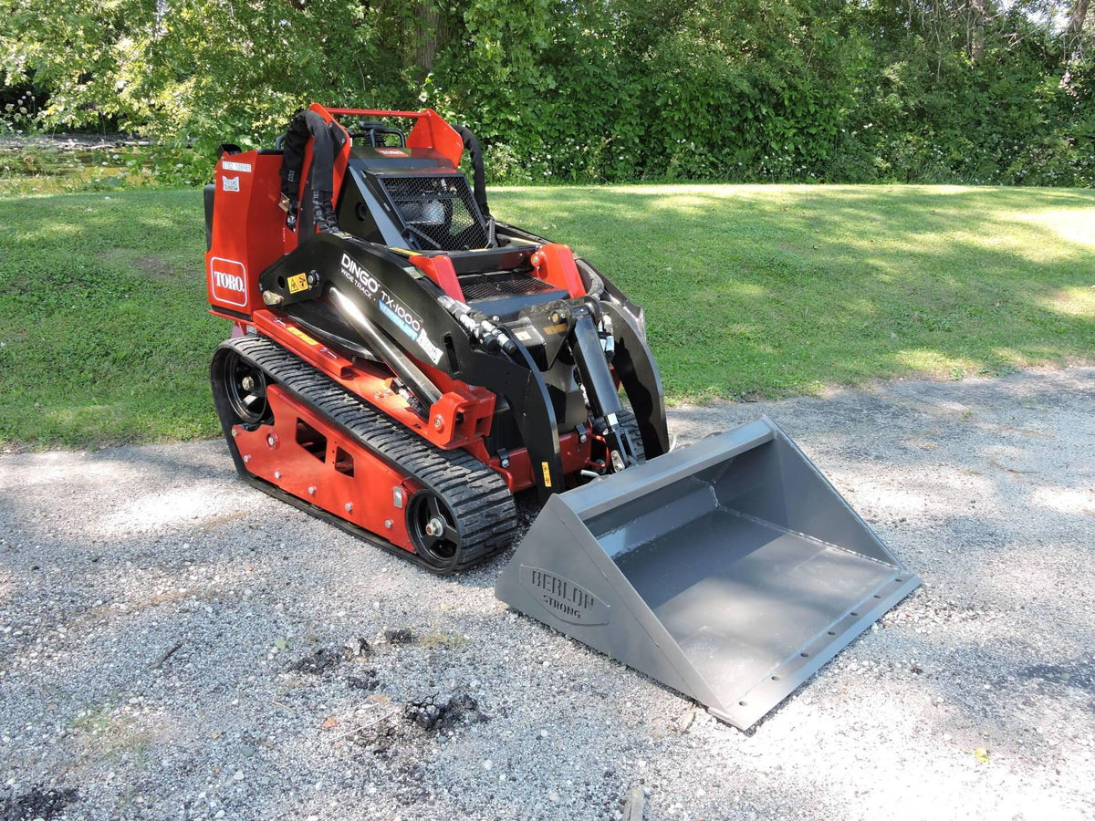 mini skid steer with the extended lip low pro bucket in action