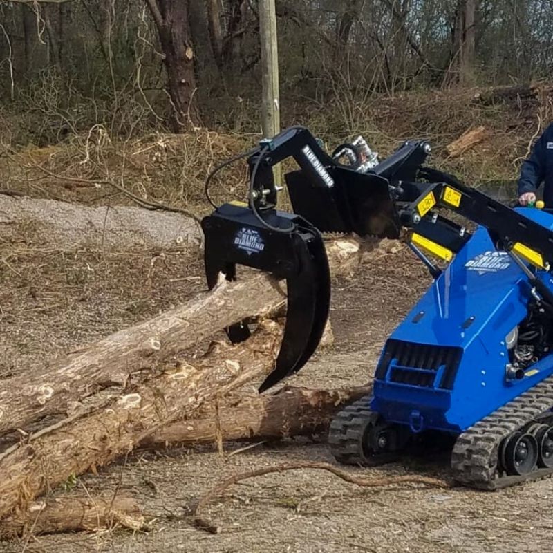 mini skid steer in action with the blue diamond mini log grapple