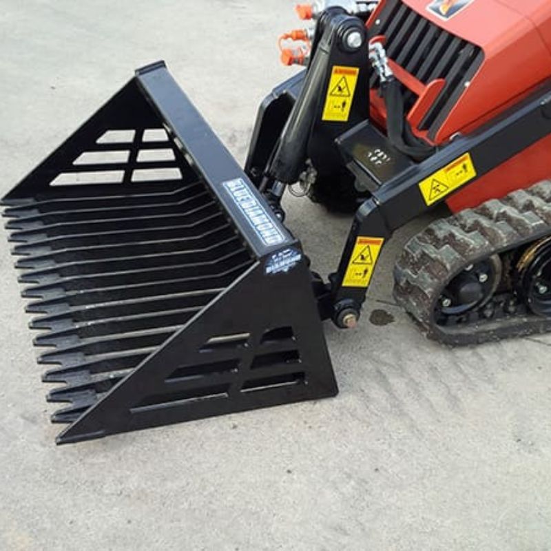 ditch witch mini skid steer with blue diamond mini rock bucket on the ground