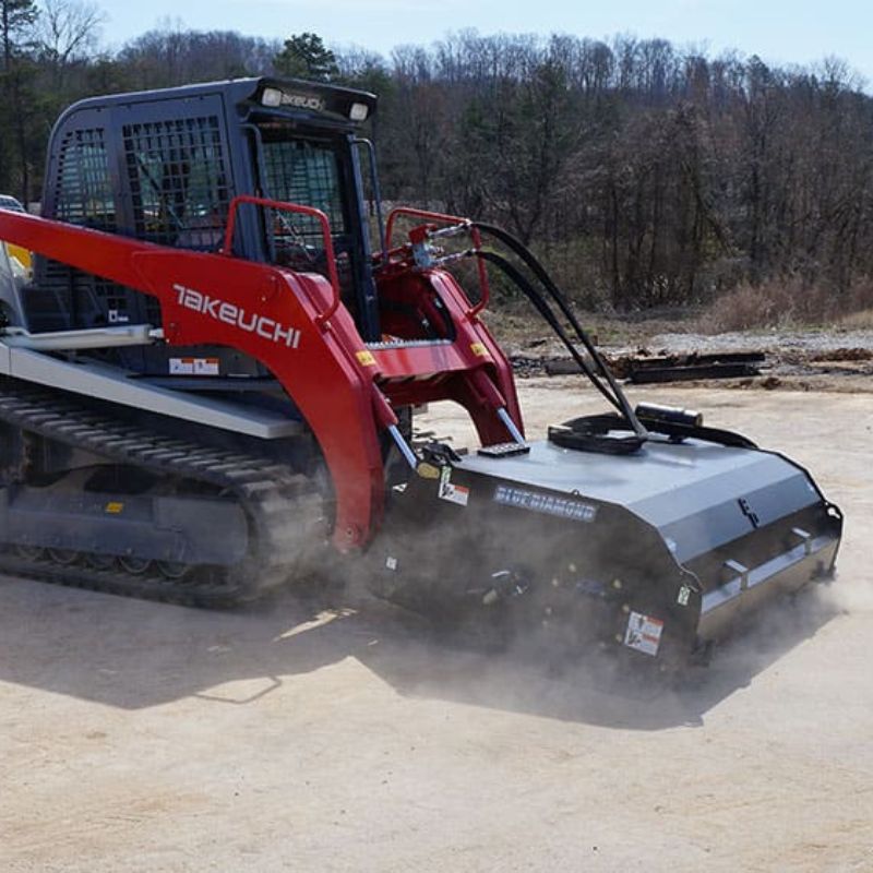 Takeuchi Skid Steer with Blue Diamond Pickup Broom Attachment in action.
