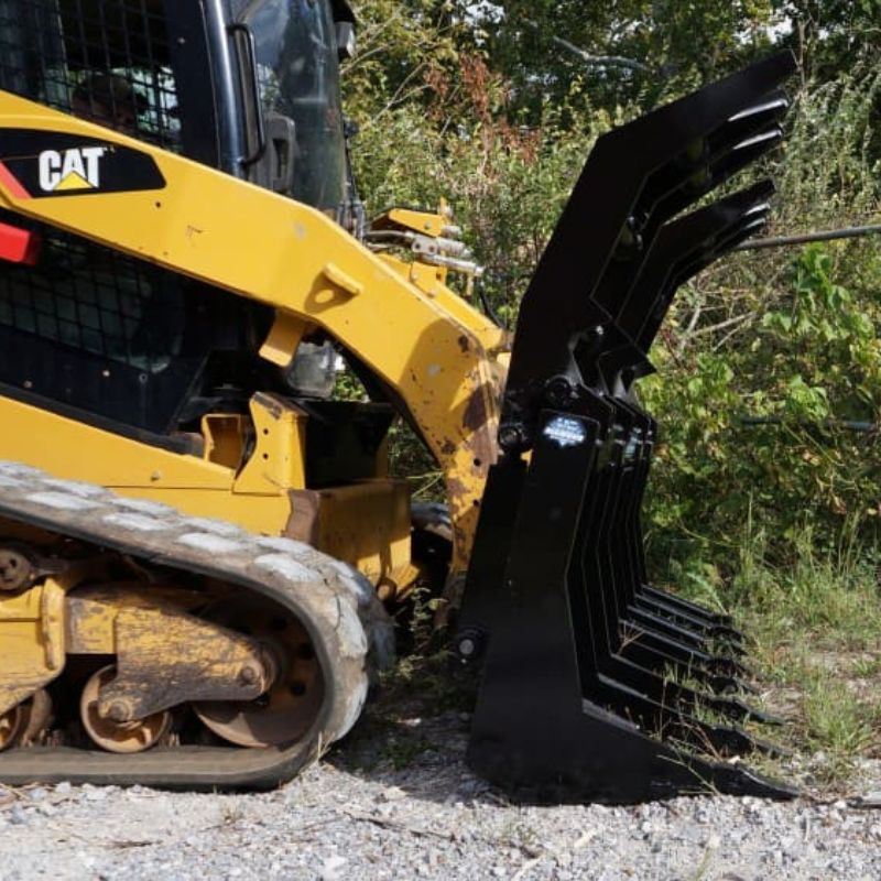 Blue diamond Severe Duty Rake Grapple Fully open and attached to CAT skid steer