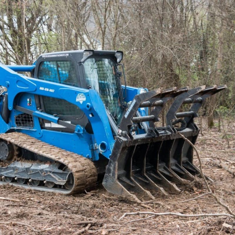 severe duty rake grapple attachment in action by blue diamond