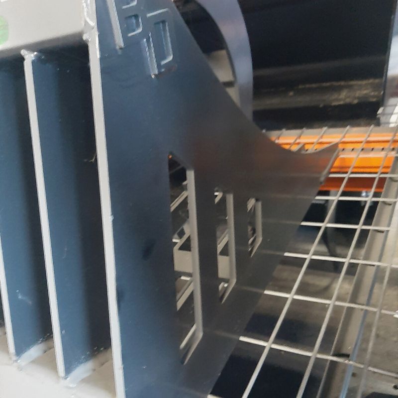 Close-up of a Blue Diamond standard-duty rock bucket grapple showing steel side plates and cutout design