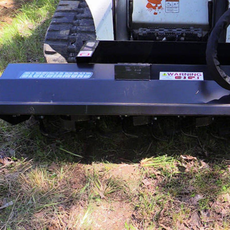 bobcat skid steer with the blue diamond rotary tiller in the field