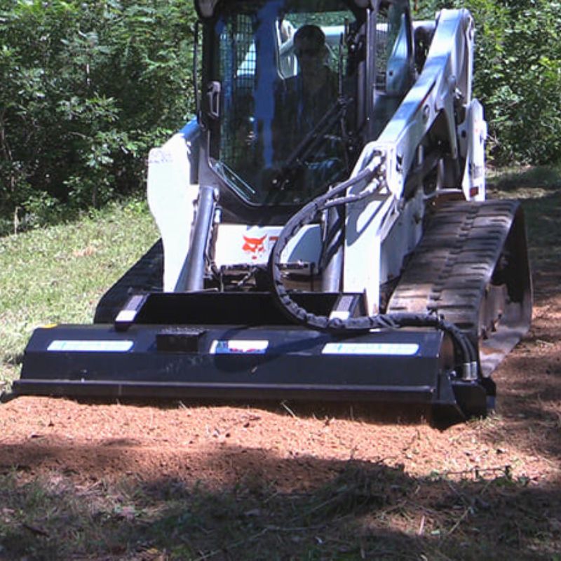 skid steer in action with the blue diamond hydraulic rototiller