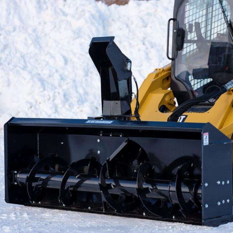 cat skid steer with the blue diamond extreme duty snow blower in snow ground