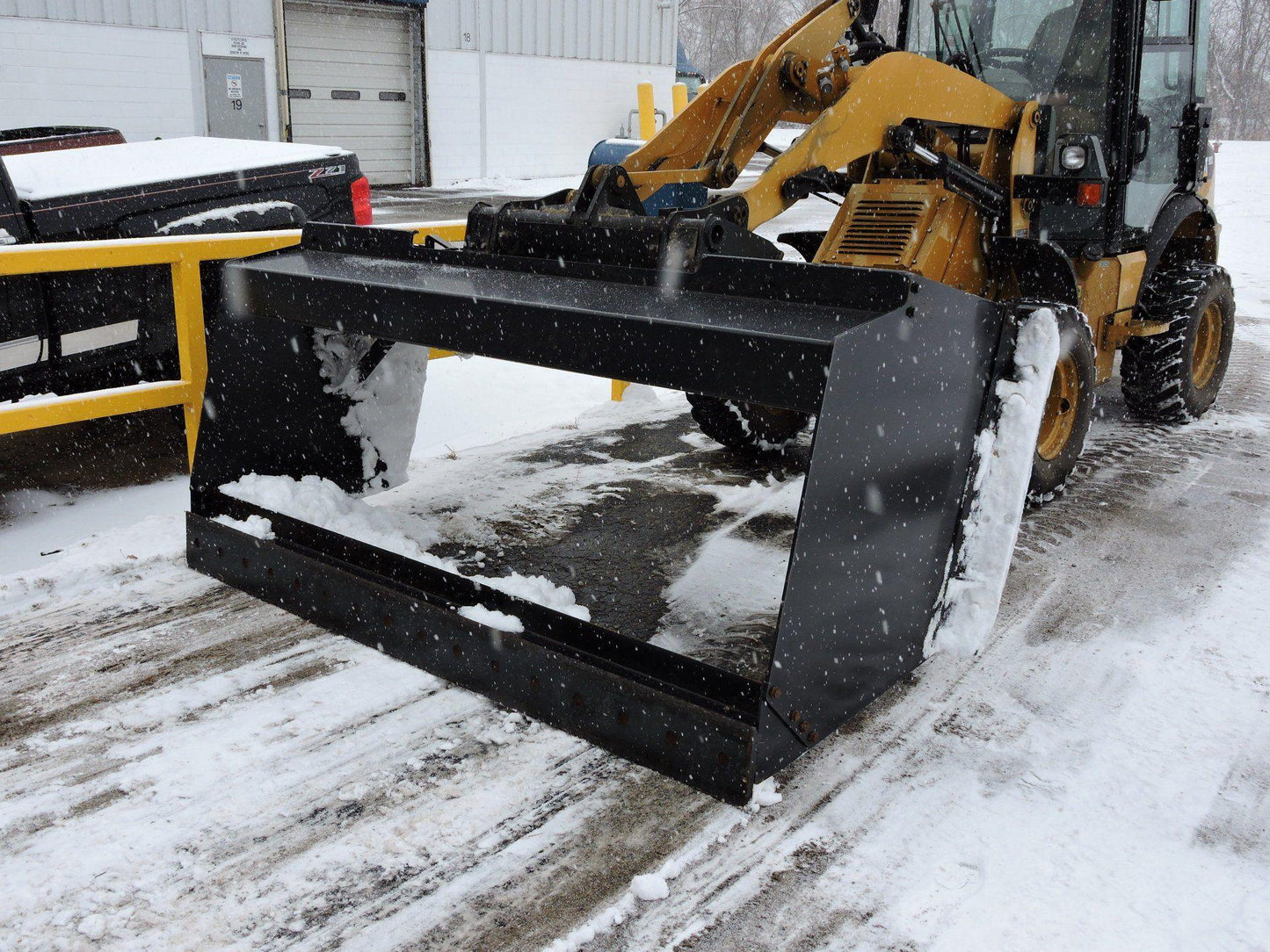 Skid Steer In the snow ground with the Snow Pusher attachment for Skid Steer & Tractor from Berlon Industries Snow Pusher Berlon Industries