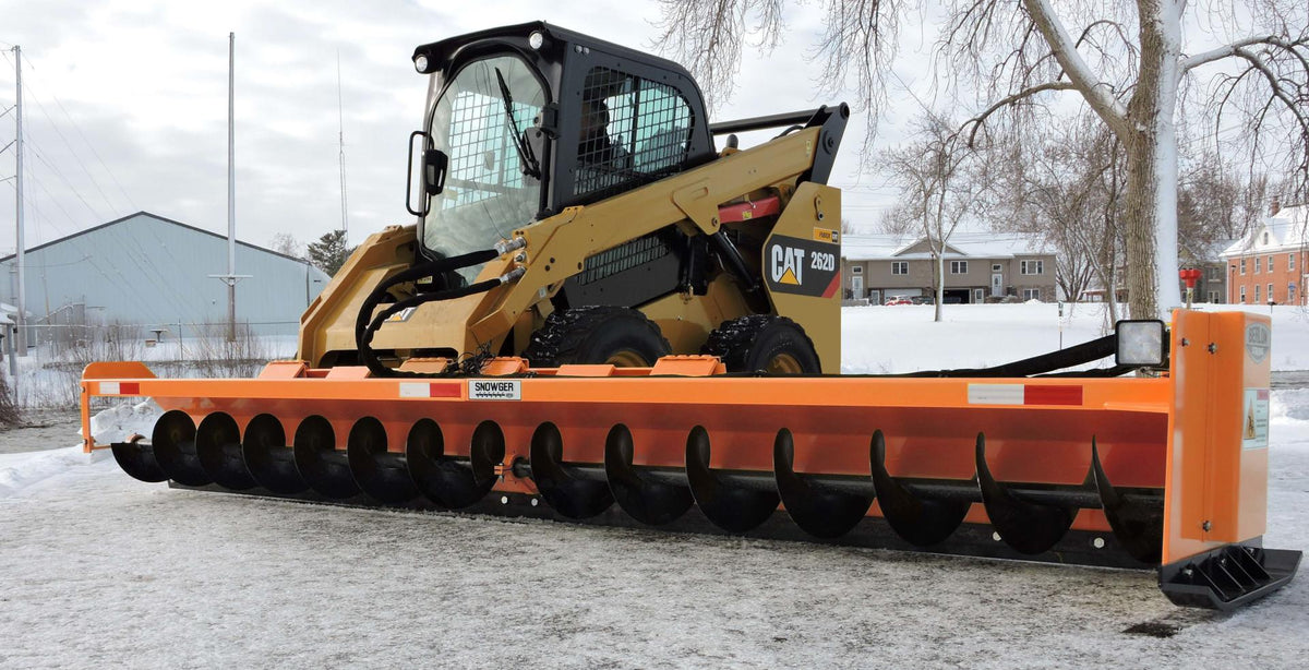 Cat Skid Steer in action with the Snowgrr™ Attachment from Berlon Industries for Skid Steer and Tractor