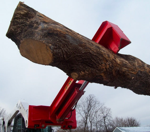A TM Manufacturing pro series log splitter lifting a large log