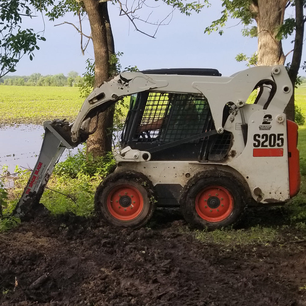 bobcat skid steer with tm manufacturing spade blade attachment