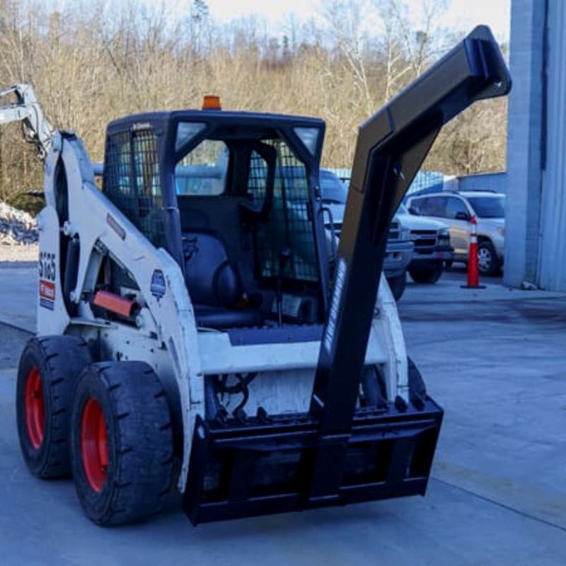 skid steer with the blue diamond tree boom attachment