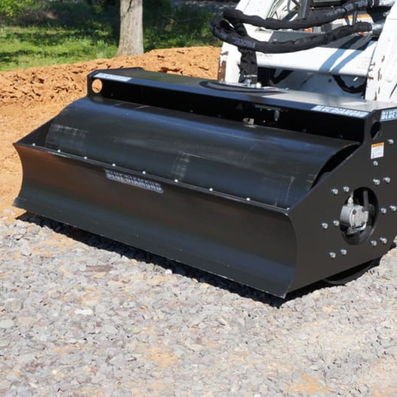 skid steer with the blue diamond vibratory roller in the field