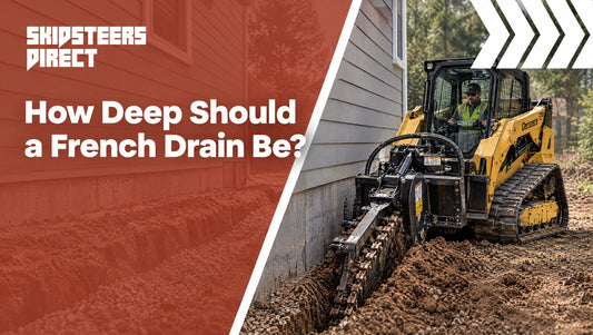 A skid steer trencher digging a drainage trench along the side of a house foundation.