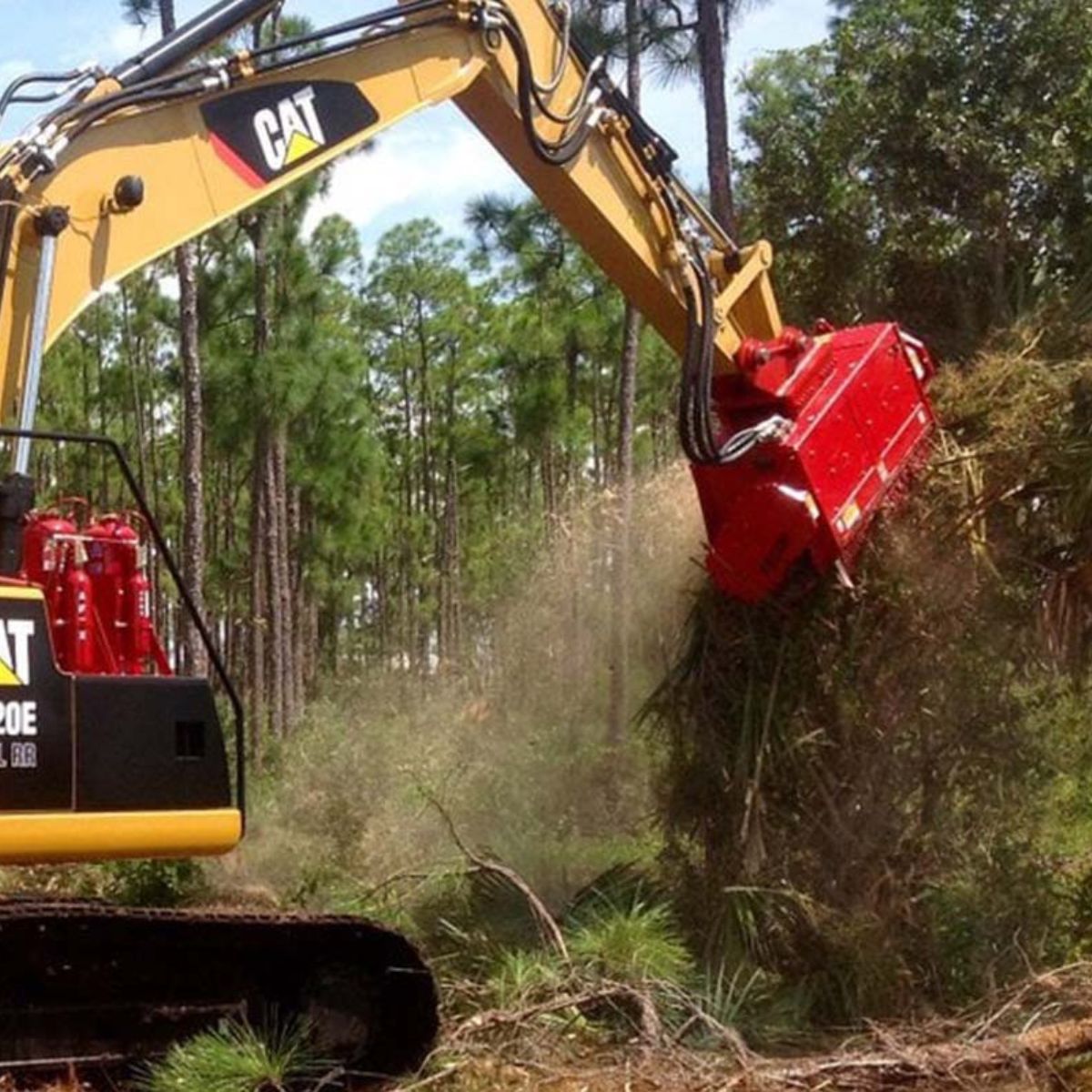 mulching-trees-and-brushes-with-the-CEM36-attachment-by-fecon-on-a-cat-excavator