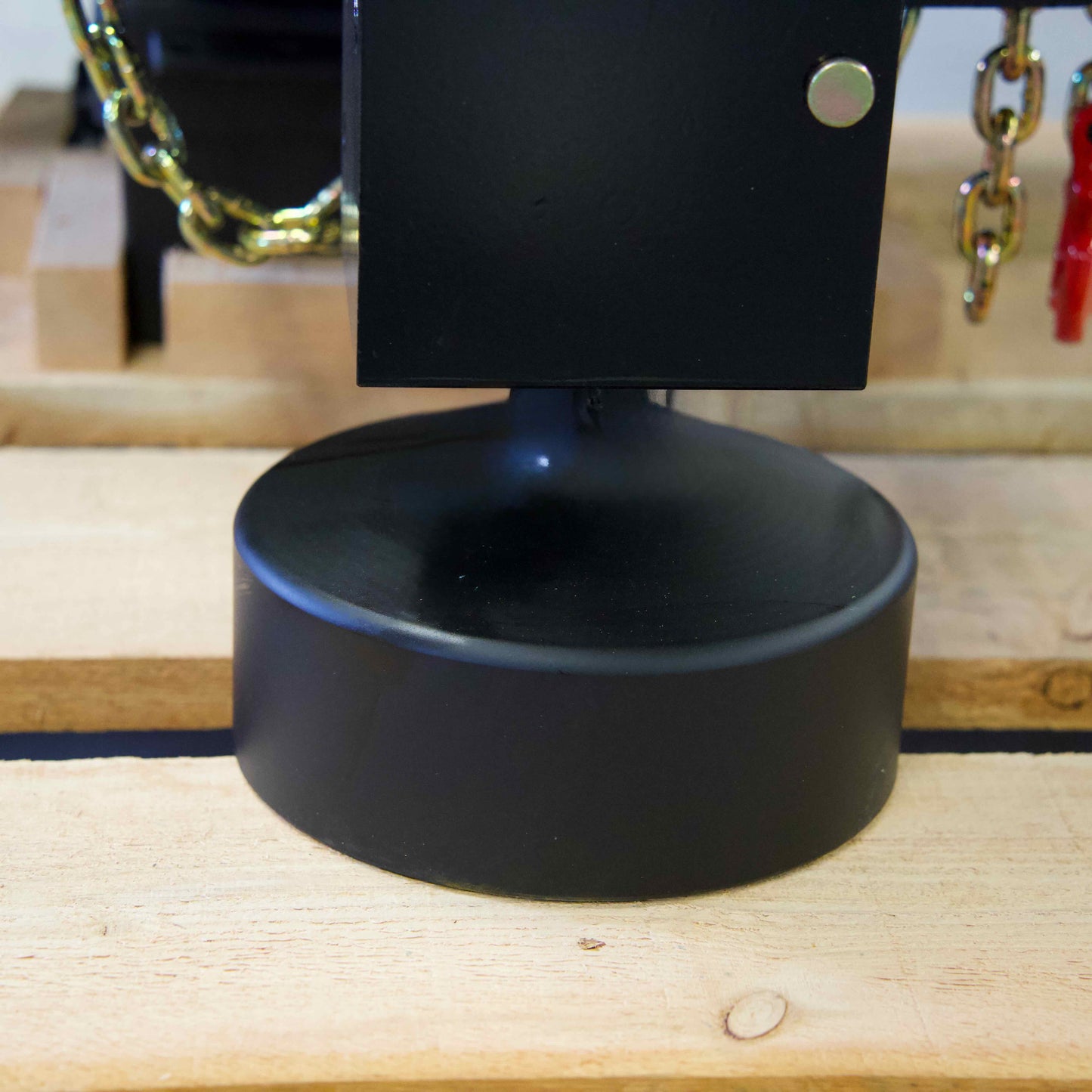 Round flat Montana post driver tool resting on a wooden pallet