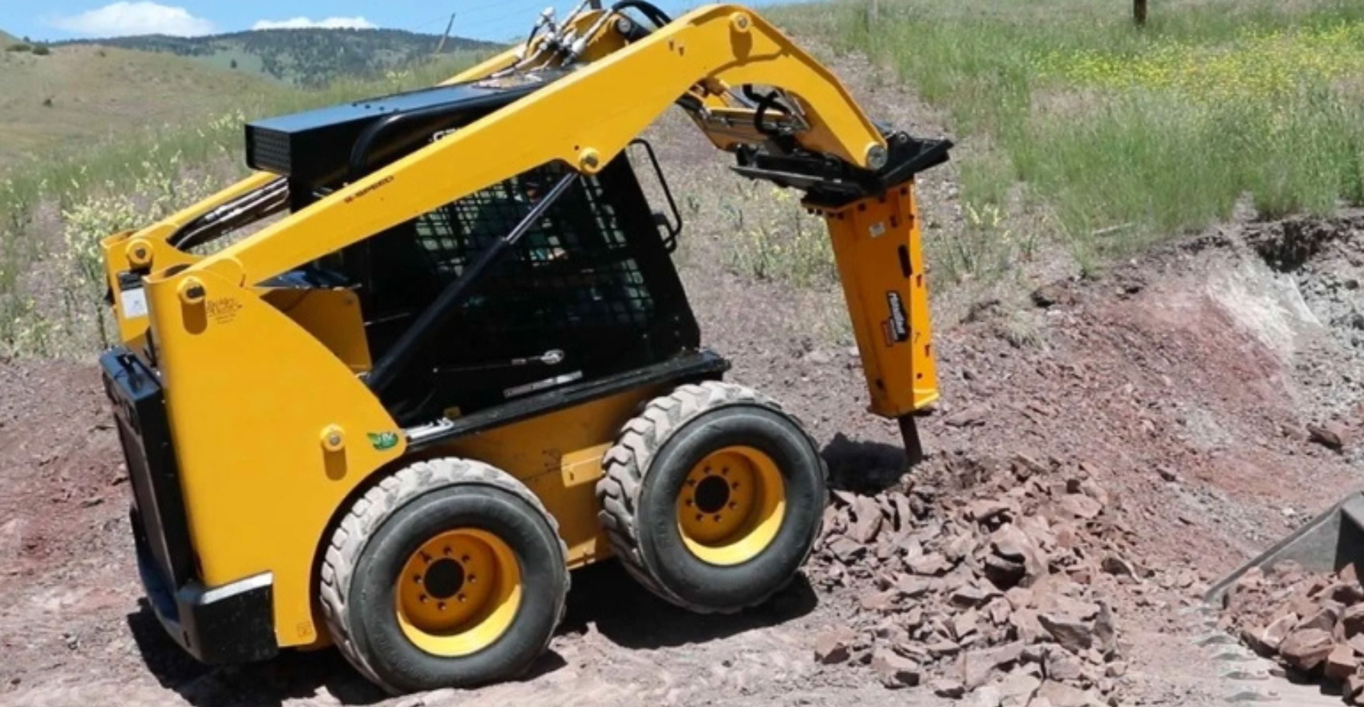 montana-breaker-on-skid-steer-breaking-dirt-up