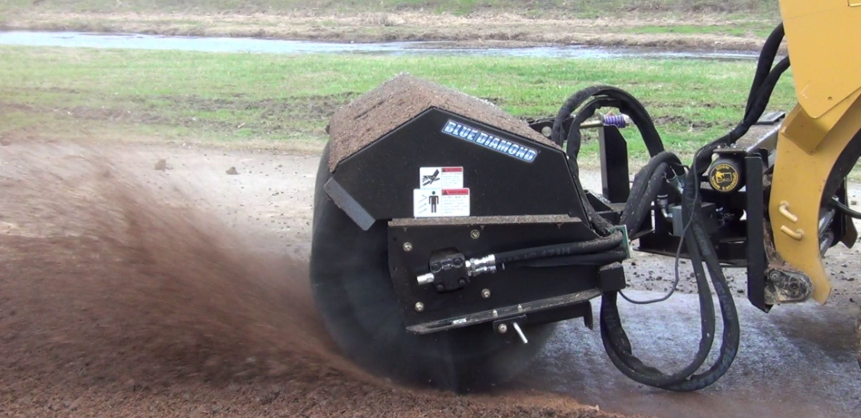 Blue diamond skid steer angle broom attachment in action