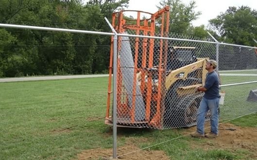 Man easily install fence with the EZG fence hog attachment