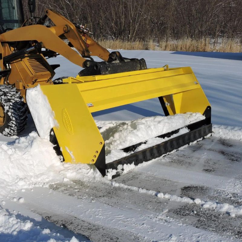 skid-steer-pushing-snow-using-the-snow-pusher-attachment-in-the-field