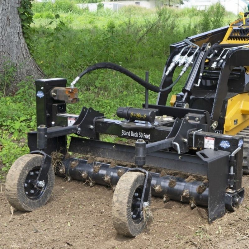 Heavy duty power rake attachment by Blue Diamond in the forest