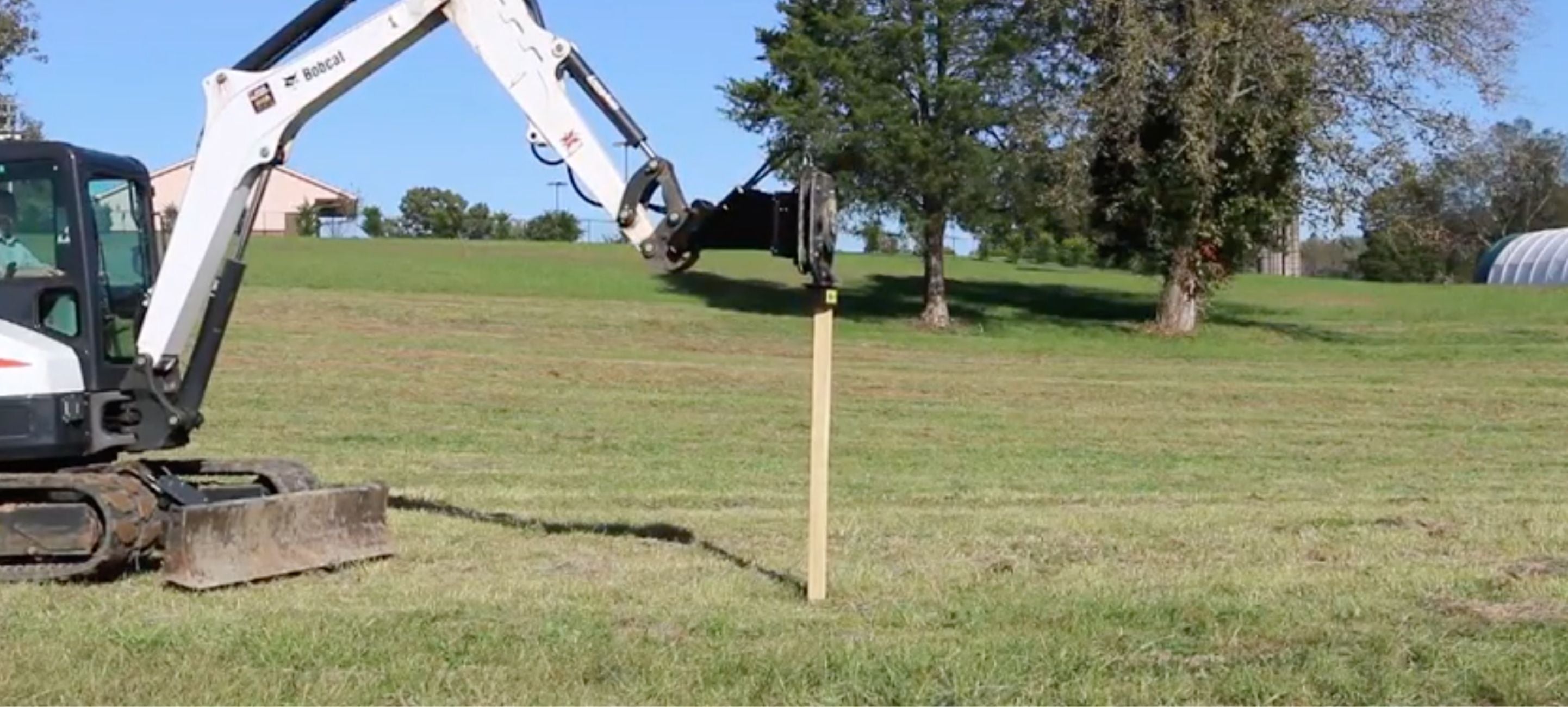 Bobcat with the blue diamond post driver attachment for excavator. 