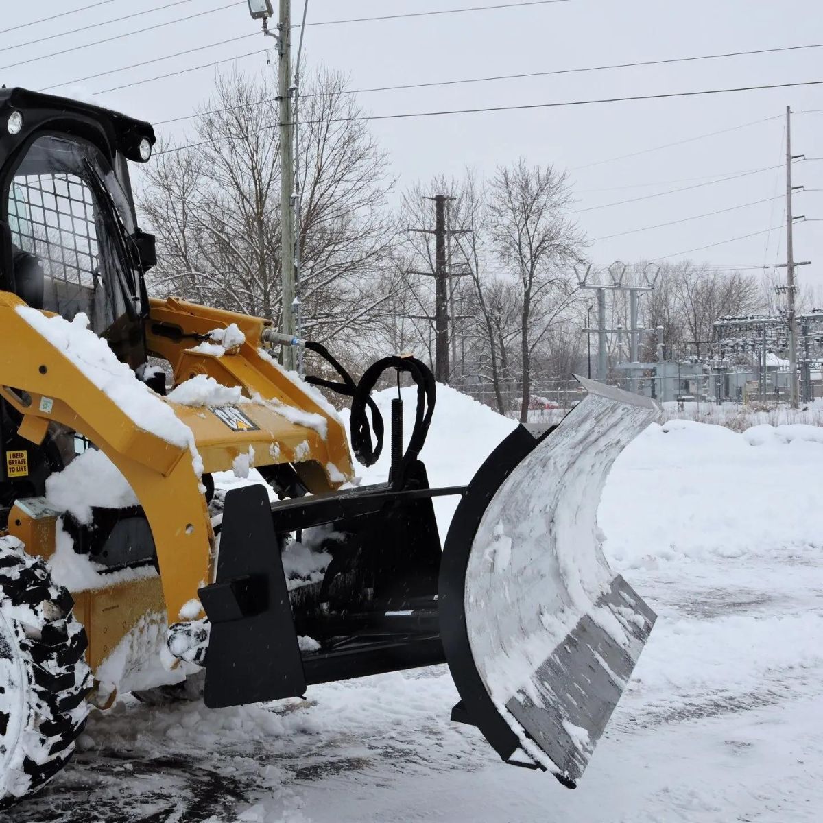 cat skid steer with a snow plow