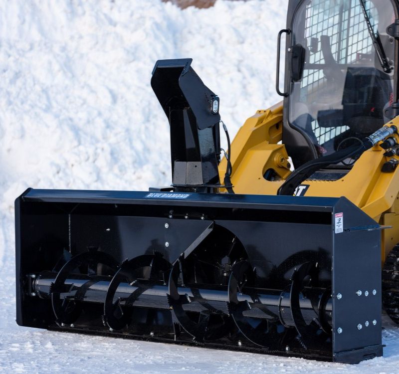 cat skid loader with a blue diamond snow blower