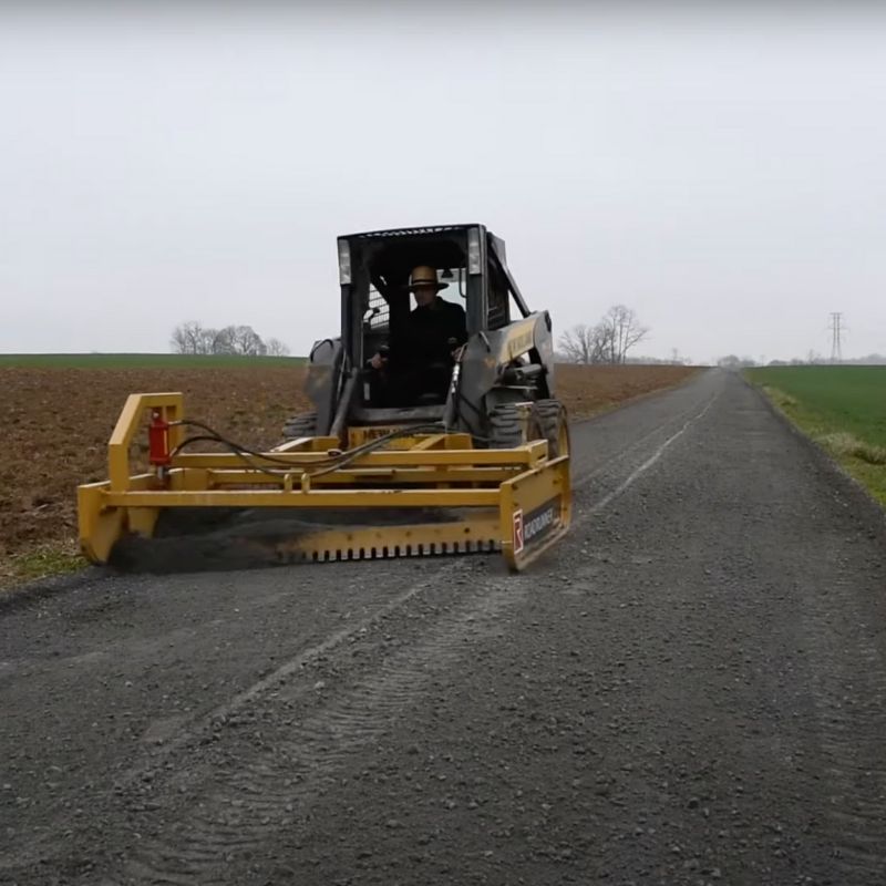 skid-steer-with-the-roadrunner-grader-attachment-grading-the-road