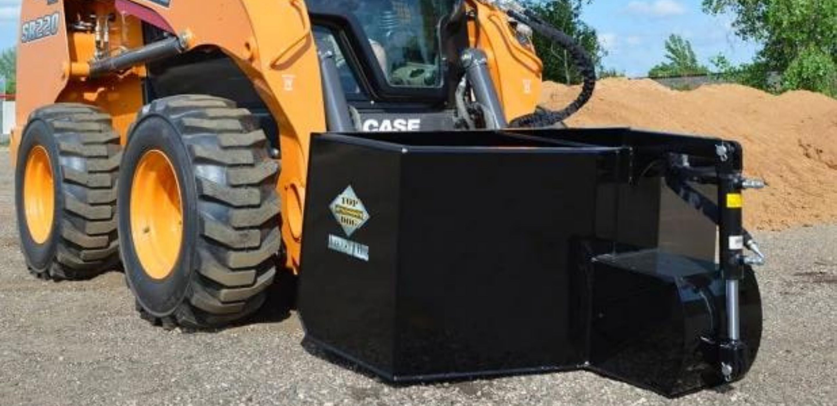 Case skid steer with the hopper attachment from Top Dog