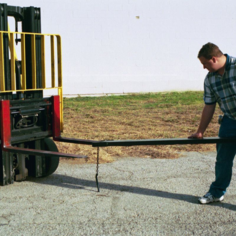 Inserting the fork extension on a forklift