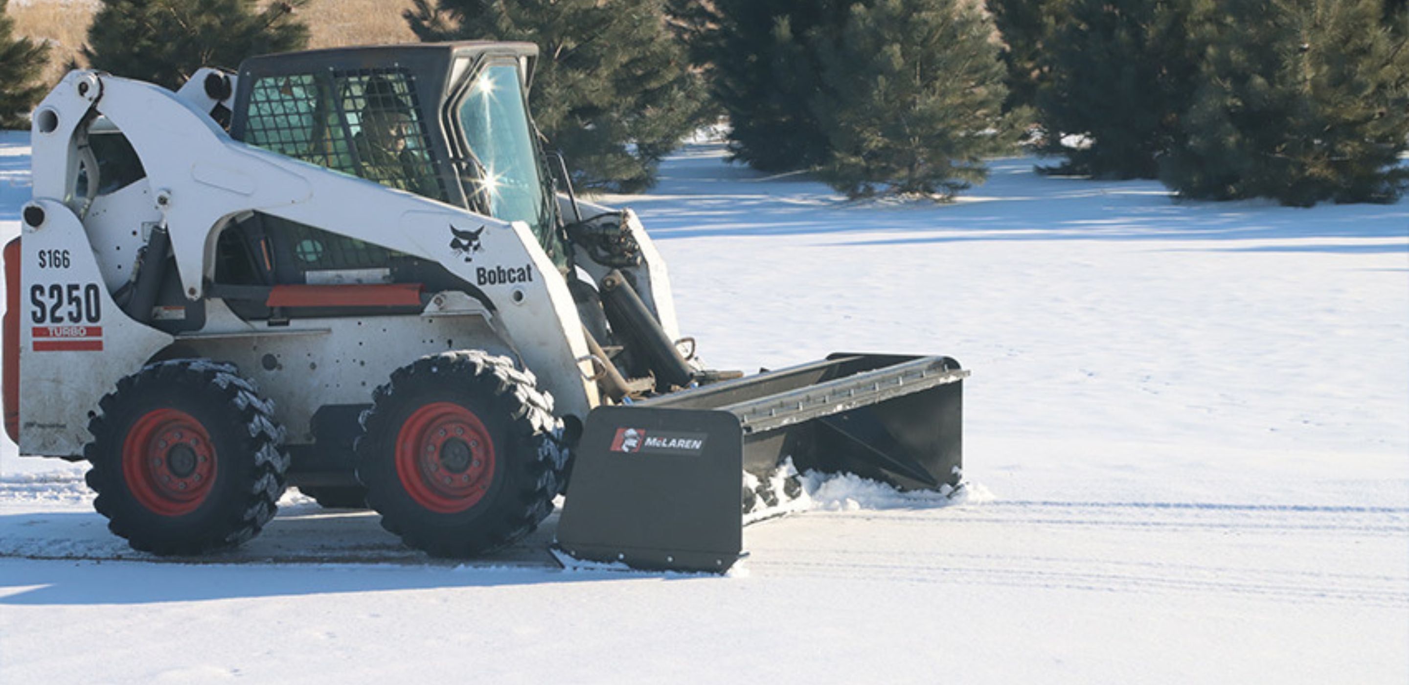 bobcat-skid-steer-with-the-mclaren-snow-pusher-attachment-in-the-field