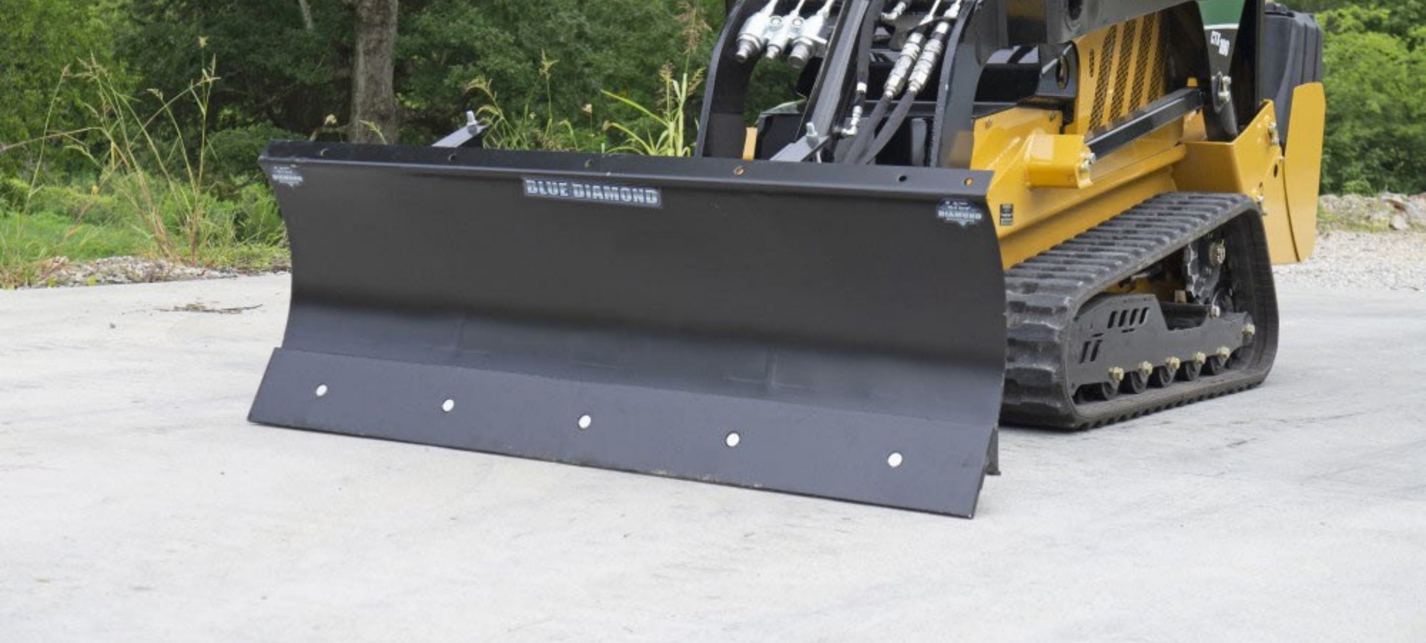 Mini skid steer with the dozer plow attachment by Blue Diamond