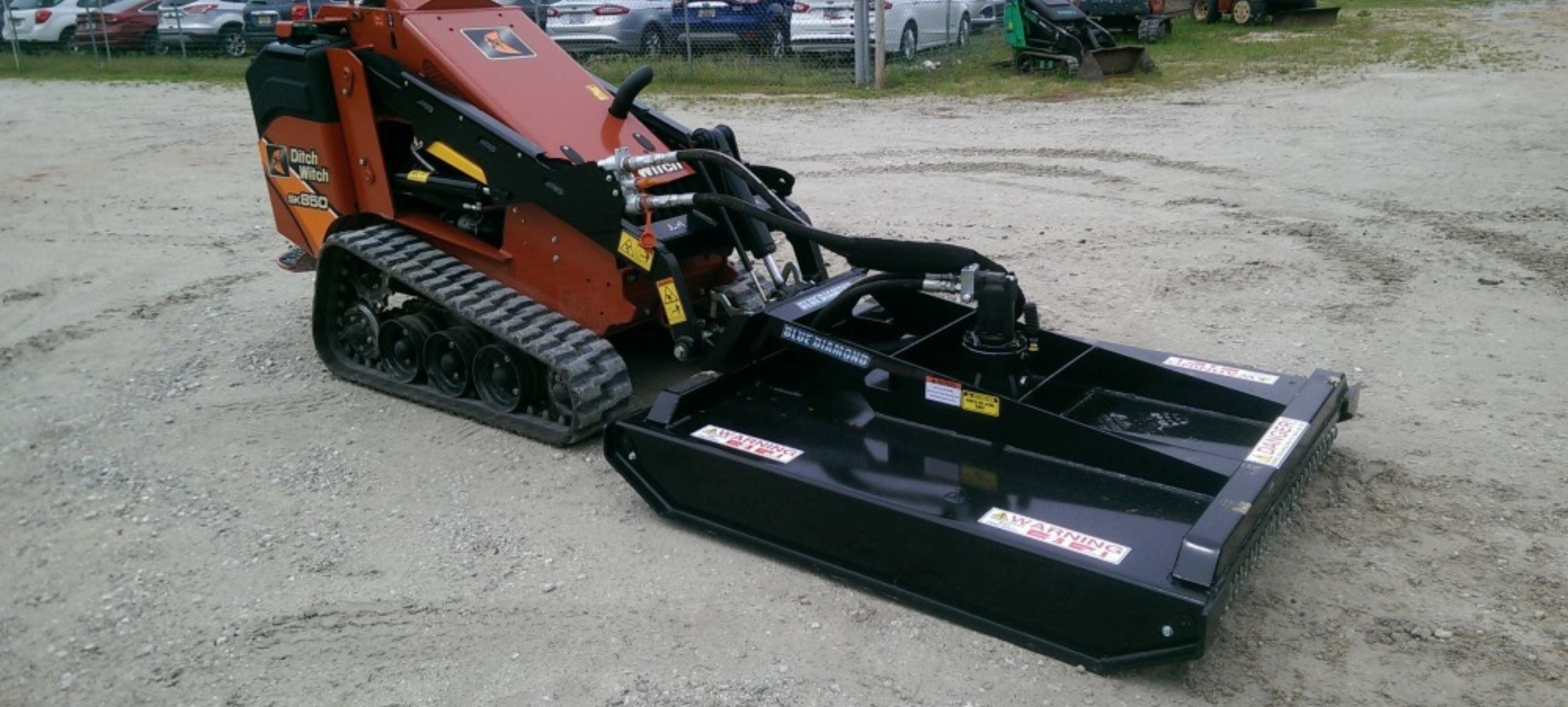 Ditch Witch mini skid steer with the Blue Diamond brush cutter attachment in the field for sale