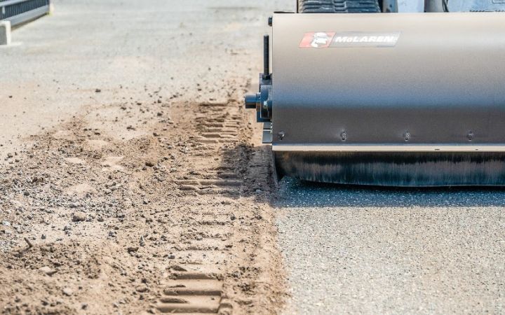 Bobcat skid steer with the mclaren pick up broom attachment. 