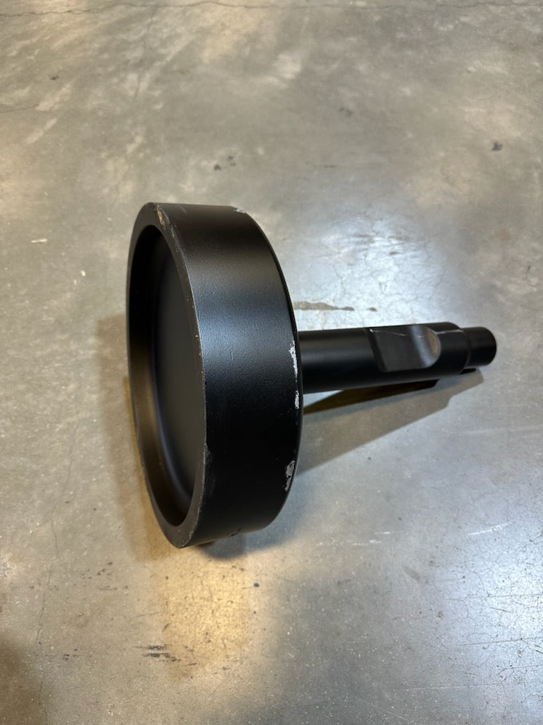 Black metal attachment with a round flat base and cylindrical shaft