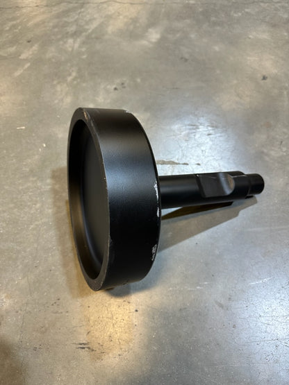 Black metal attachment with a round flat base and cylindrical shaft